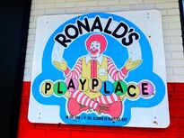 Ronald's Playplace sign out in front of an entrance. They can sometimes be seen outside a restaurant or inside McDonald's Playplaces.
