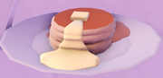 A stack of pancakes with butter.