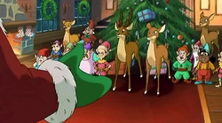 Mitzi and the other villagers listening to Santa.