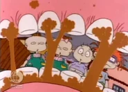 Angelica eats the dog biscuits noisily, unaware that they're not really cookies