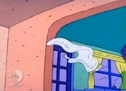 As Stu and Didi walk back into the kitchen, Tommy takes off his diaper and tosses it out of the playpen one last time