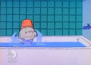 ...Tommy continues playing in the bathtub with his clothes on