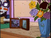 Chaz happily places the picture frame of Melinda on a table.