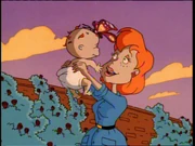 Melinda holding her infant son in a flashback.