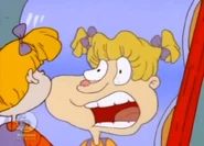 Angelica sees her swollen nose in Lou's fun house mirror