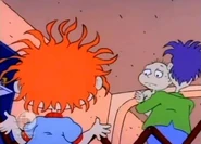 Tommy waves sadly to Chuckie as Stu takes him away
