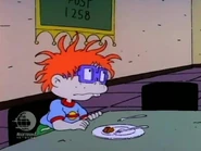 As Lou continues his speech, Tommy and Chuckie duck under the table