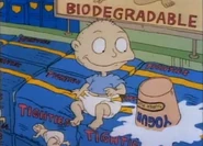 Tommy and a carton of yogurt land on packs of Tighties diapers