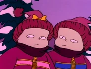 Phil and Lil watch Angelica sled down the hill