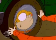 Angelica sees her swollen nose in the hubcap of Charlotte's car