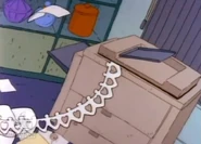 ...and she has somehow turned his fax machine into a paper doll machine