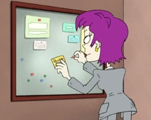 Beverly pinning her contact information on the bulletin board, moments before meeting Susie.
