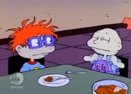 Tommy tries to pull off the Baby Suspenders, but to no avail