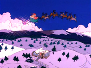 Santa flies off into the distance.