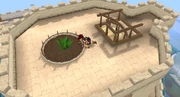 A player harvests the enriched snapdragon from the farming patch on the top of the castle.