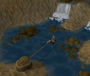 A player swimming to the 2nd island with the aid of a rope.