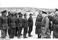 Rommel (long coat) inspecting troops of the Indian Legion.