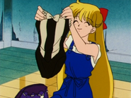 Minako holding her swimsuit