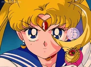 Sailor Moon holding the Moon Stick with the Silver Crystal upon it.