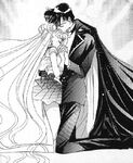 Sailor Moon and Tuxedo Mask embracing.