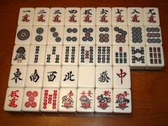 Mahjong tiles, including four season tiles not used in Saki.