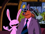 [4] In the background, we see a sculpture of Max with a tennis racket behind a tennis court background.