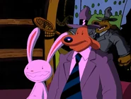 [3] In the background, we see a sculpture of Sam with a tennis racket behind a tennis court background.