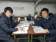 Sugiyama (left), pictured with Satō Fumiyasu (right), in SASUKE 36