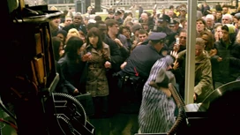 The police push people back to stop the trap