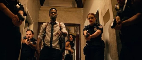 Zeke approaches the box as the officers aim their weapons at it