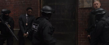 Halloran, Keith, and the SWAT team raid Eleanor's studio