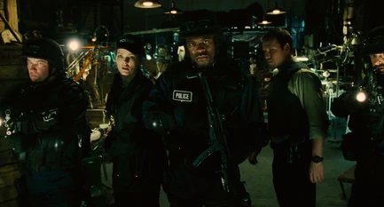 Eric, Kerry, Rigg, and the SWAT team approach Jigsaw