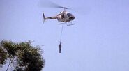 Sosa's helicopter with Omar Suarez' body hanging.