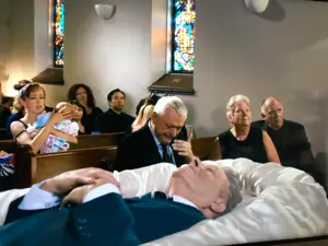 Gwen and the minister (right) at Carl’s funeral