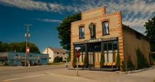 Main Street featuring Café Tropical in the foreground and Bob's Garage in the background