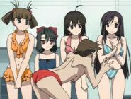 Hikari in her orange swimsuit admiring Taisuke's red swimsuit