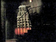 An Imperial Dalek "climbs" the stairs.