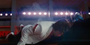 Scott causes Gideon to fall down the stairs.