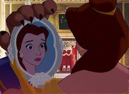 Belle and Beast holding the Magic Mirror 'In case of emergencies' at Buckingham Palace