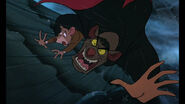 Ratigan grabs and growls angrily at Basil and is about to scratch him