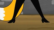 A closeup of Claudette Dupri’s black boots