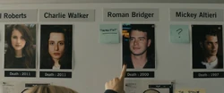 Kirby pointing to Roman's picture at the board at the NYPD station.