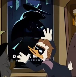 Director Boorswan in front of the film's movie poster
