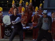 Turk is escorted to the hospital by a marching band