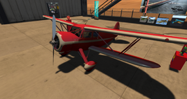 Red-painted Waco YKS-7 on display at Sunny Fields Airfield.