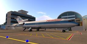 Piedmont 727 at SLIA satellite building with original terminal building (before expansion)