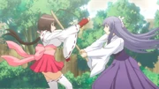 Miya is teaching Musubi how to catch the sword with her bare hands.