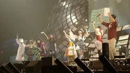 Ai along with the rest of the cast during the end Symphogear Live 2013.