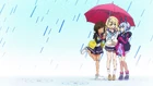 Ren, Shion and Tsubasa sheltering underneath an umbrella.