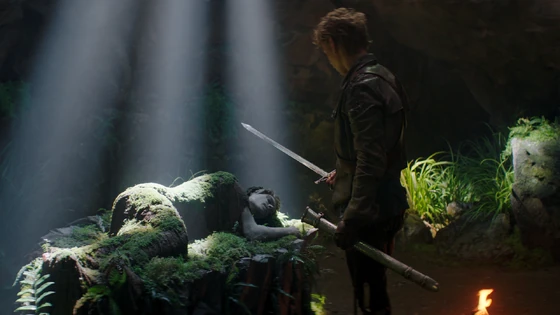 Wil looks at Shea's body resting on a stone bier inside a labyrinth of tunnels and caves in the Wolfsktaag Mountains.